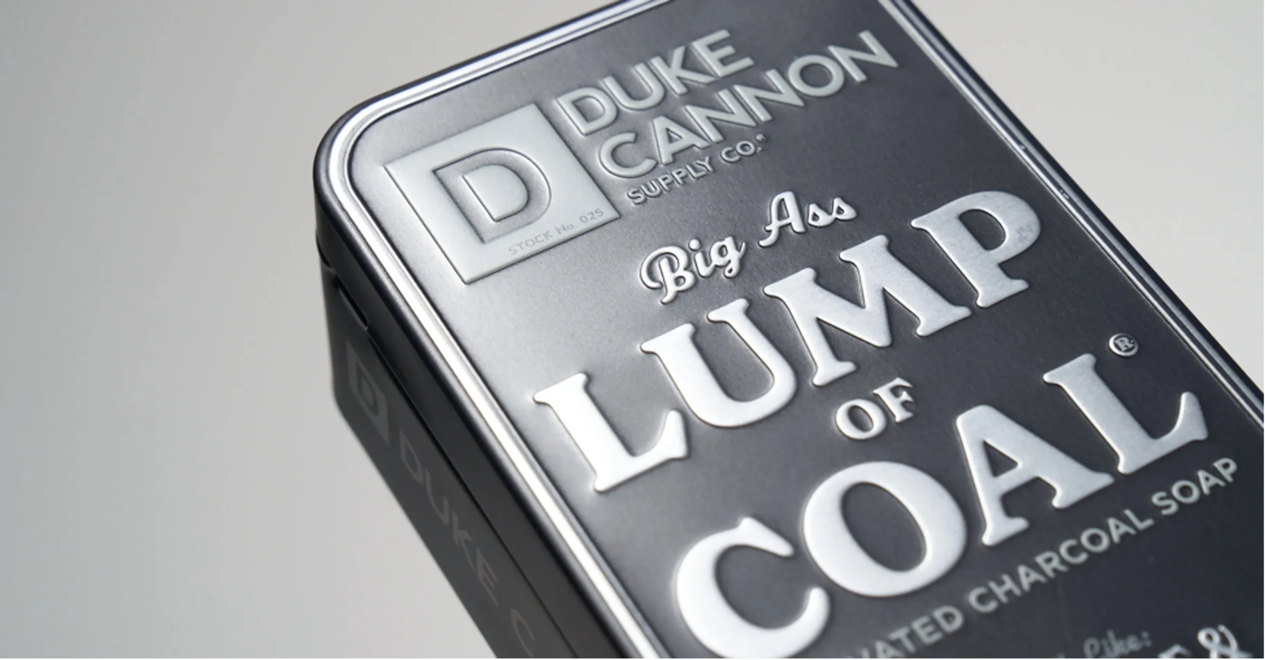 a close up of duke cannon supply's charcoal soap packaging