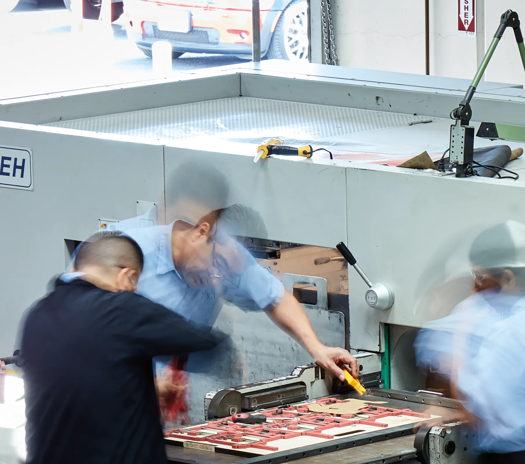 three men working in a factory setting