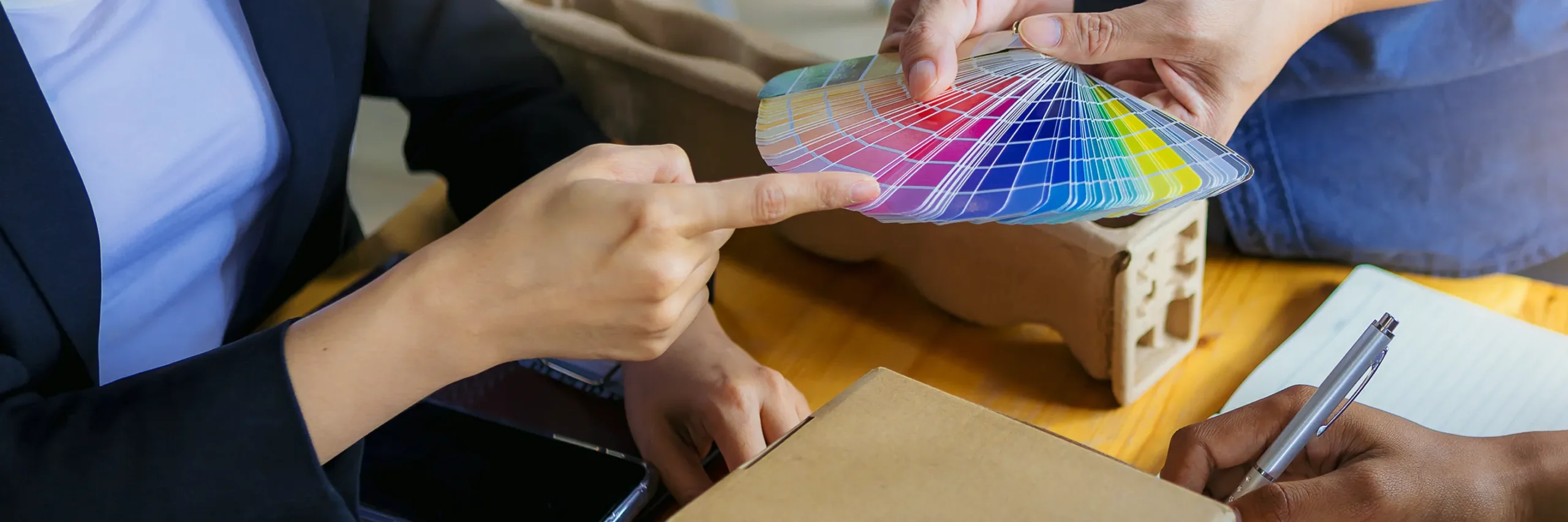 an image of a group of people with one of the people choosing through color cards