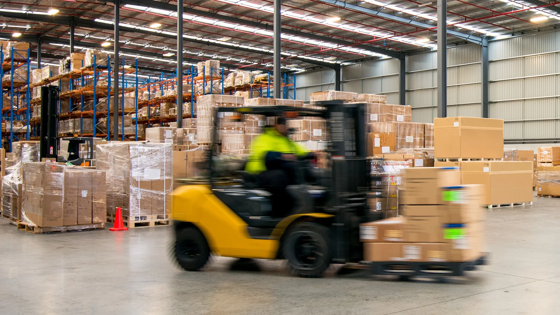 an image of a forklift driver driving through a factory setting